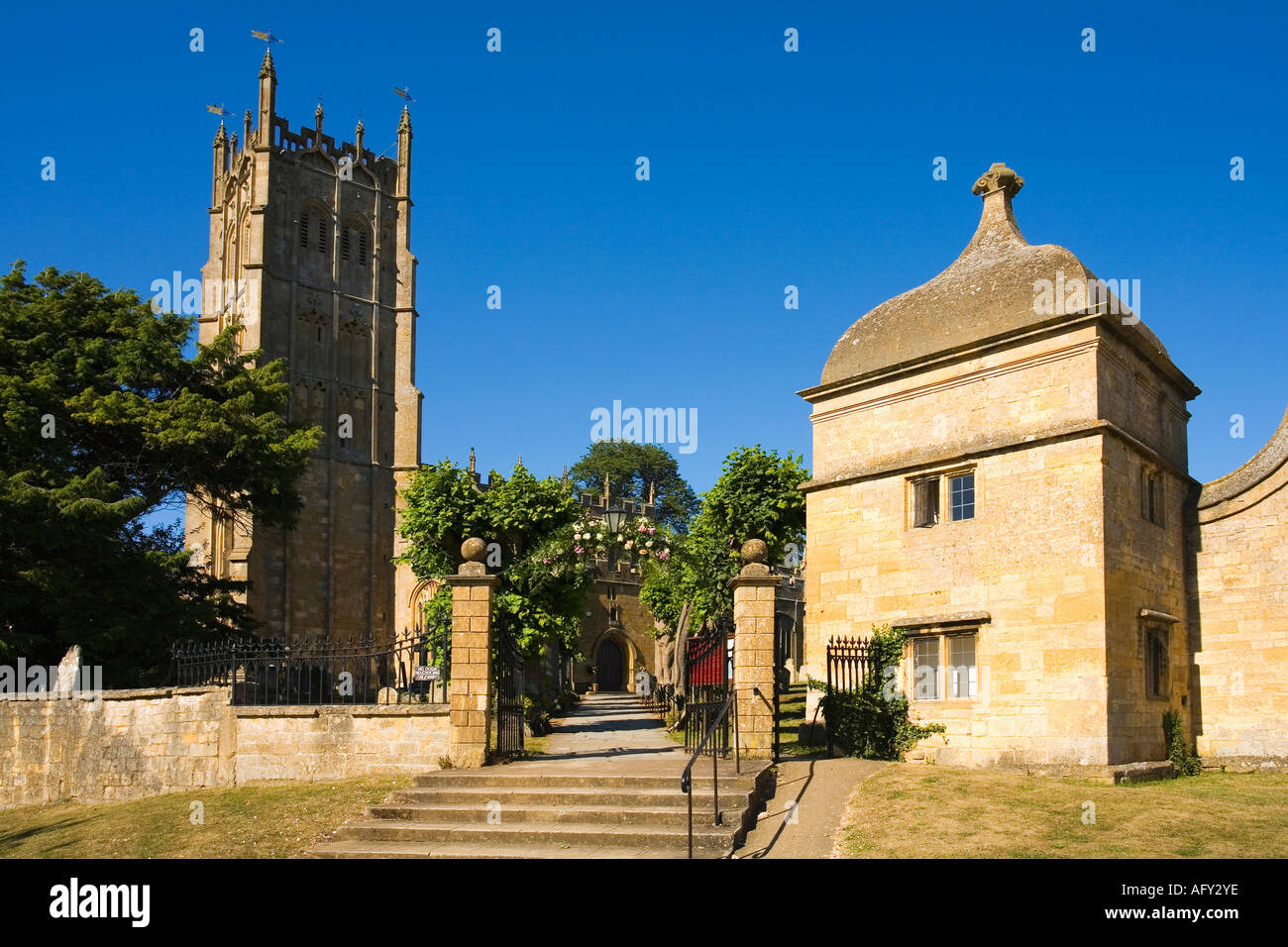 Chipping Campden english traditional church and gateway lodge in village in summer sunshine Cotswolds Gloucestershire UK GB Stock Photo