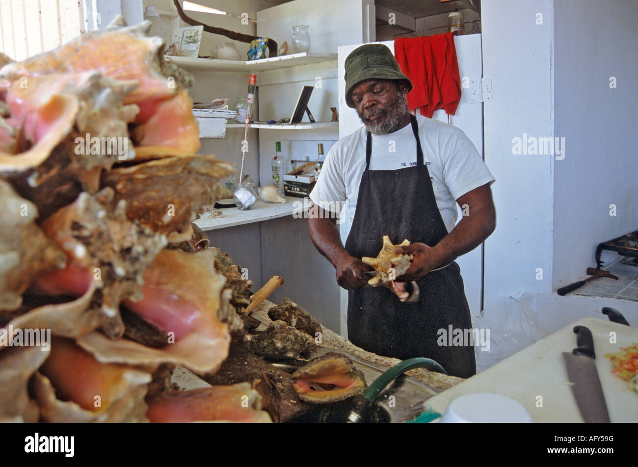 Preparing conch salad at a stand in Potters Cay Nassau Bahamas Stock Photo
