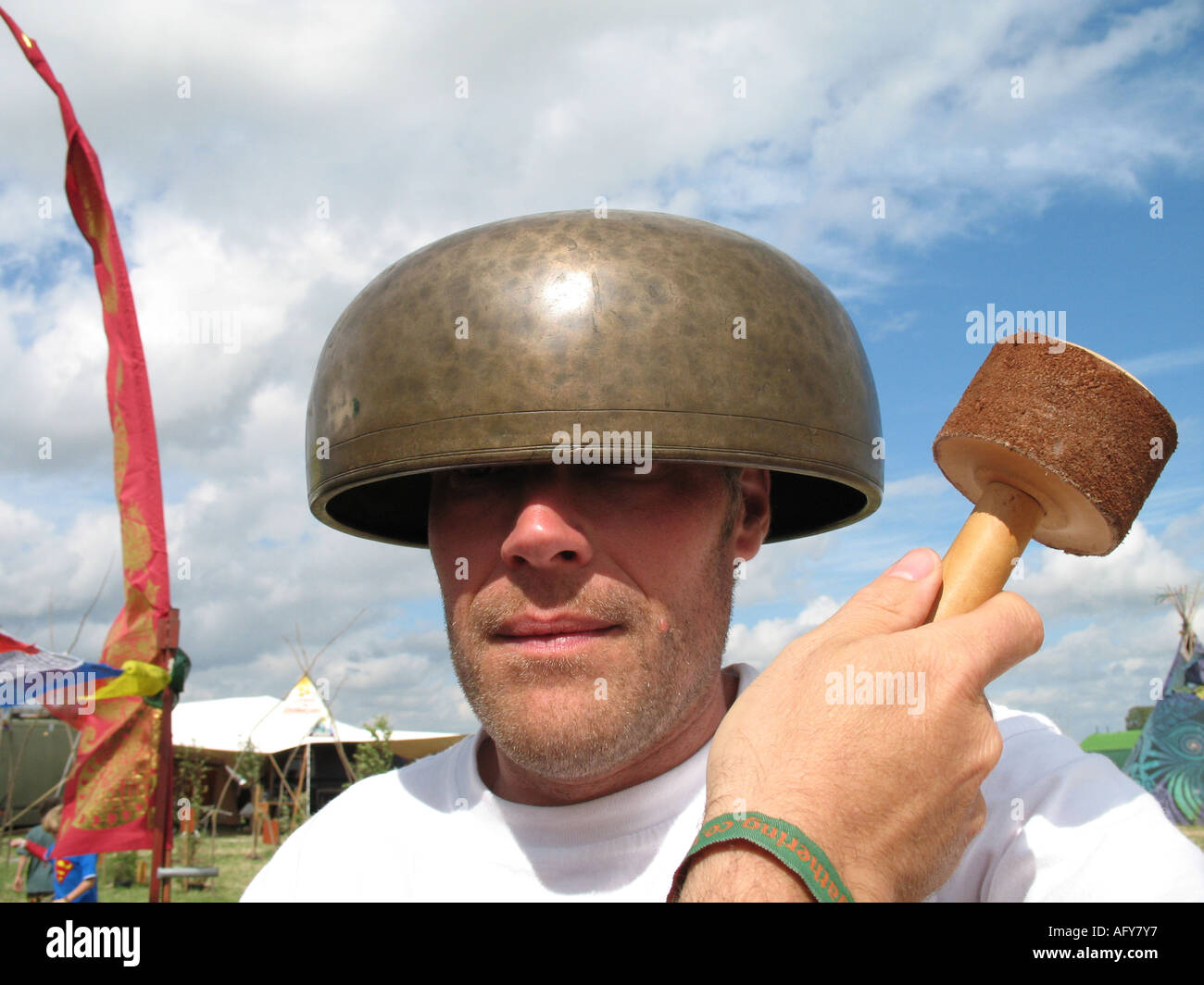 Music therapy using a Tibetan bowl at a Festival in Somerset Stock Photo