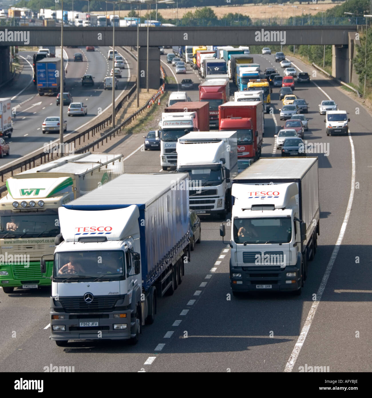 Brentwood M25 motorway junction 28 slip road heavy lorries stuck in tailback including two Tesco supermarket supply chain hgv lorry & truck drivers UK Stock Photo