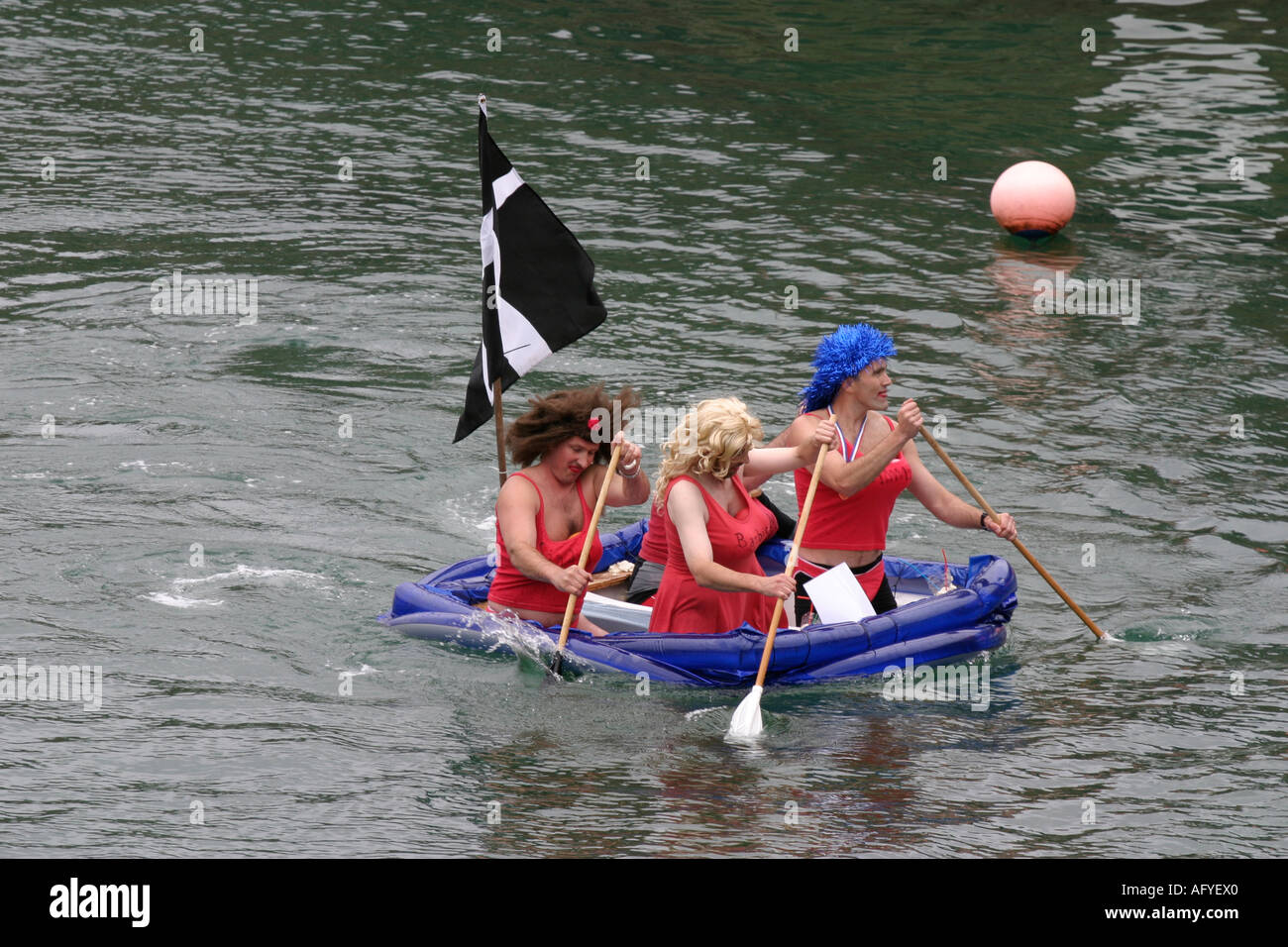Charlestown regatta Cornwall raft race baywatch babes in drag Stock