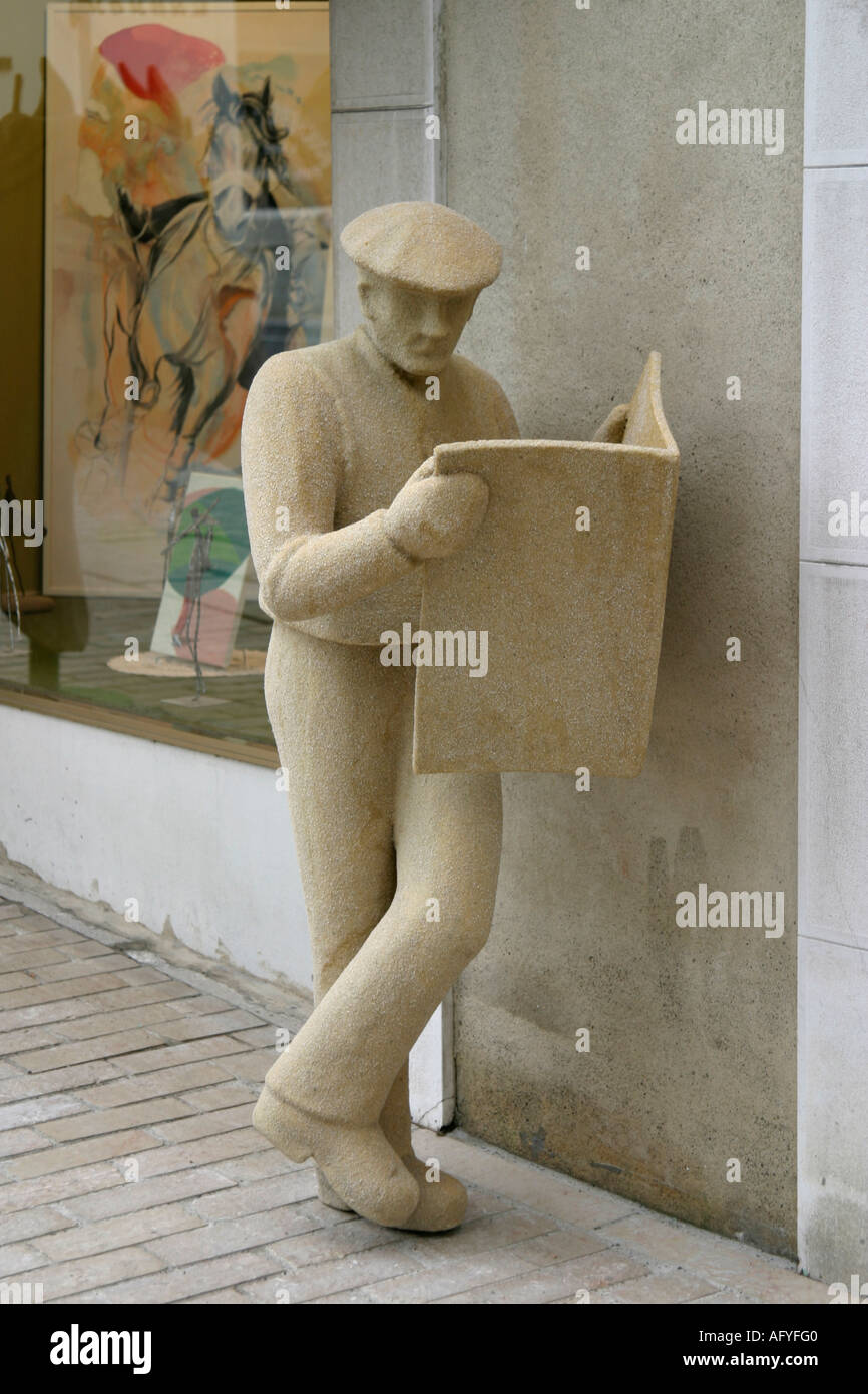Stock photograph of statue reading newspaper Stock Photo Alamy