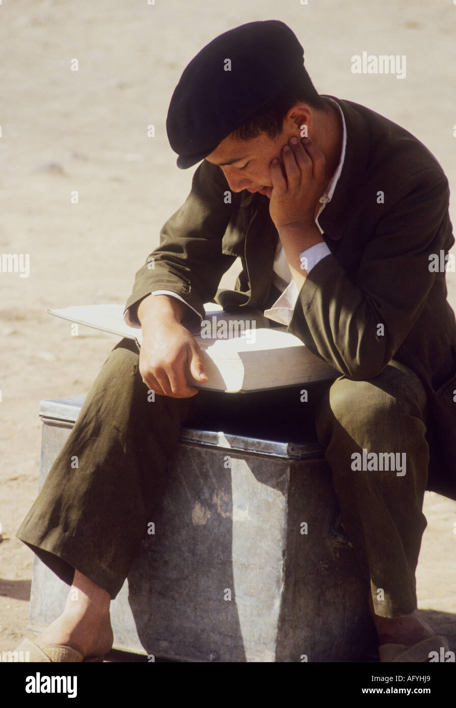 Young Islamic man/ boy reading Koran in Bokhara (Bukhara) Uzbek,marketplace ,Uzbekistan,central Asia Stock Photo