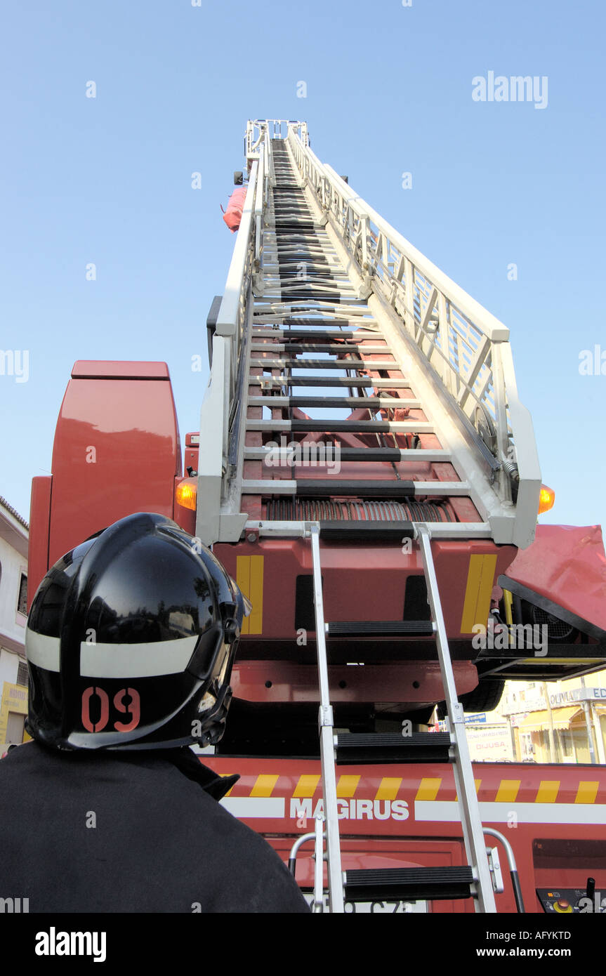 Fireman operating the ladder controls of the fire truck Stock Photo - Alamy