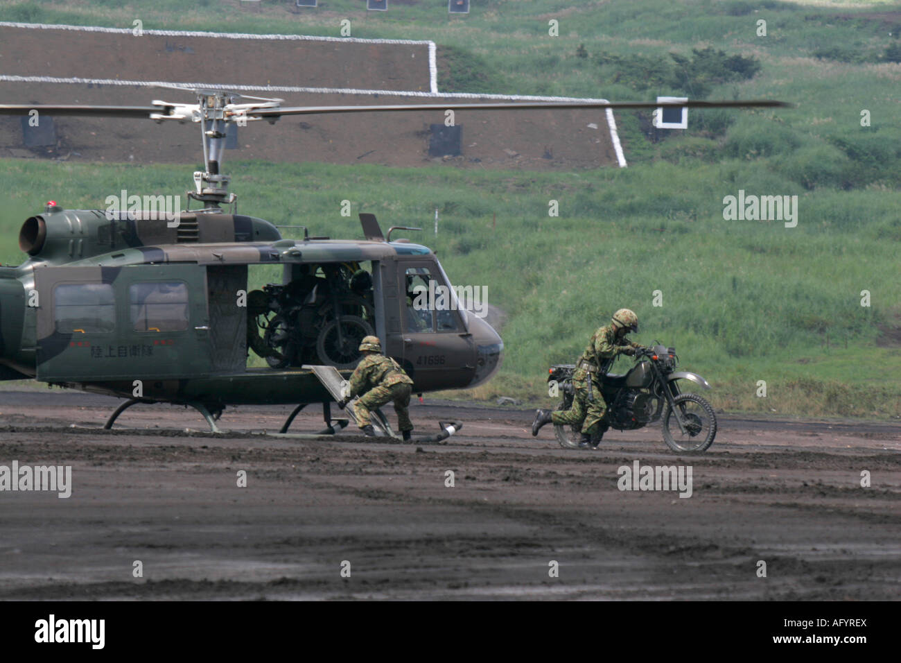 Bell UH-1 Iroquois Helicopter of Japan Ground Self Defence Foerce unloaded motorcycle Stock Photo