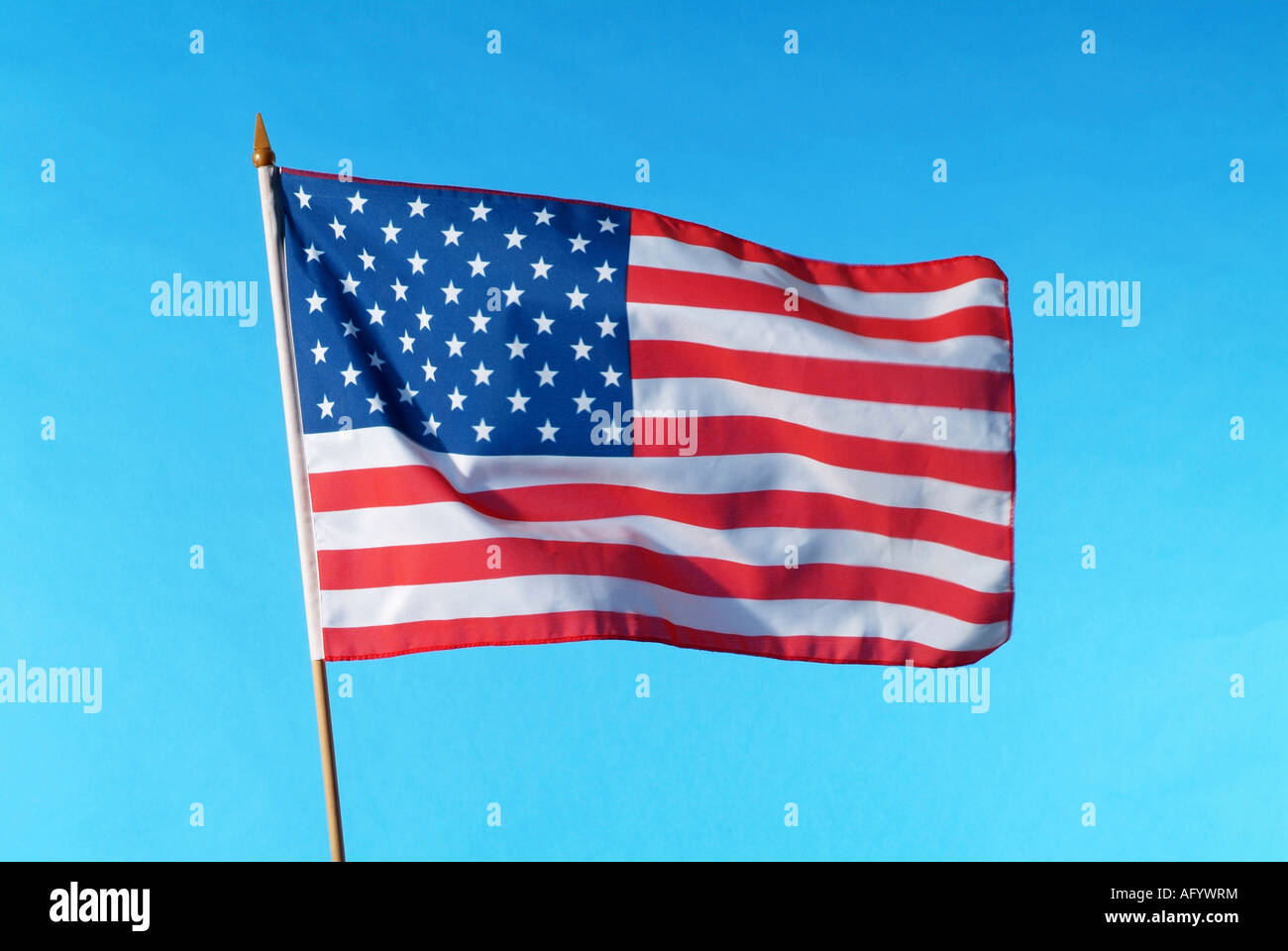 American national flag against blue sky Stock Photo - Alamy