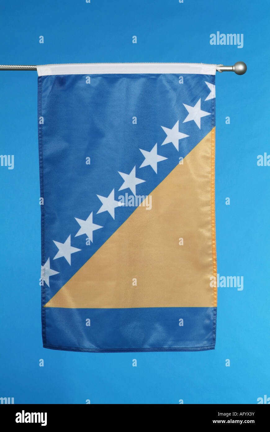 National flag of Bosnia and Herzegovina against blue sky Stock Photo