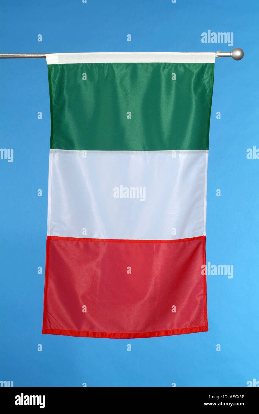 Italian national flag against blue sky Stock Photo