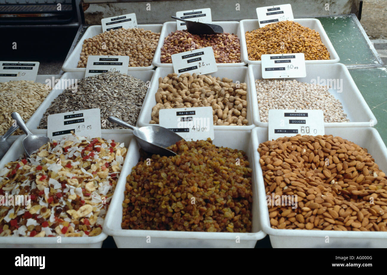 Dried fruit and nuts with spices on stall in outdoor street market in