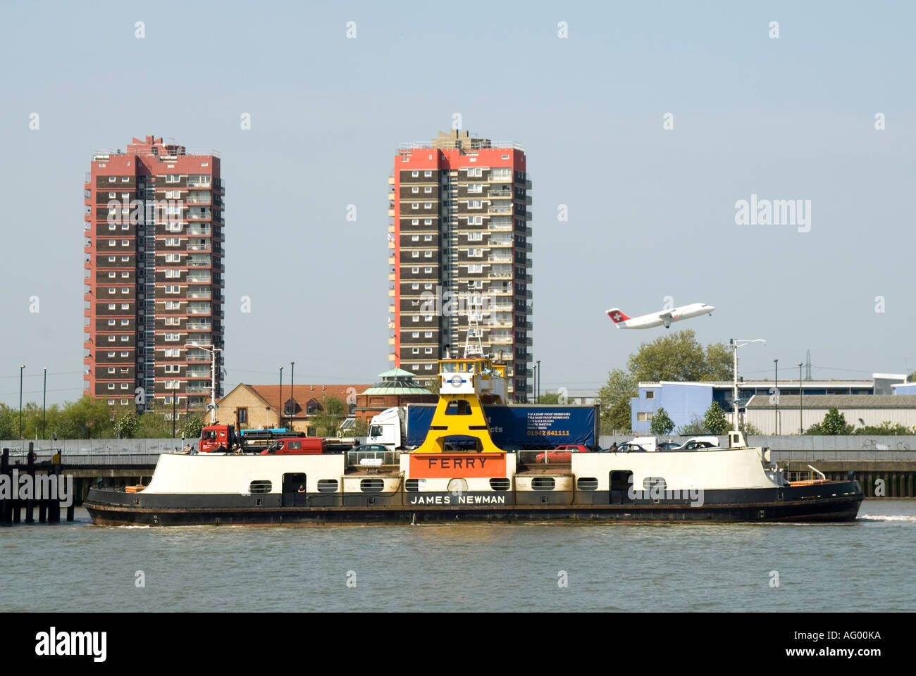 Plane taking off River Thames Woolwich town to North Woolwich TFL free public passenger transport & lorry truck car Woolwich ferry boat  England UK Stock Photo