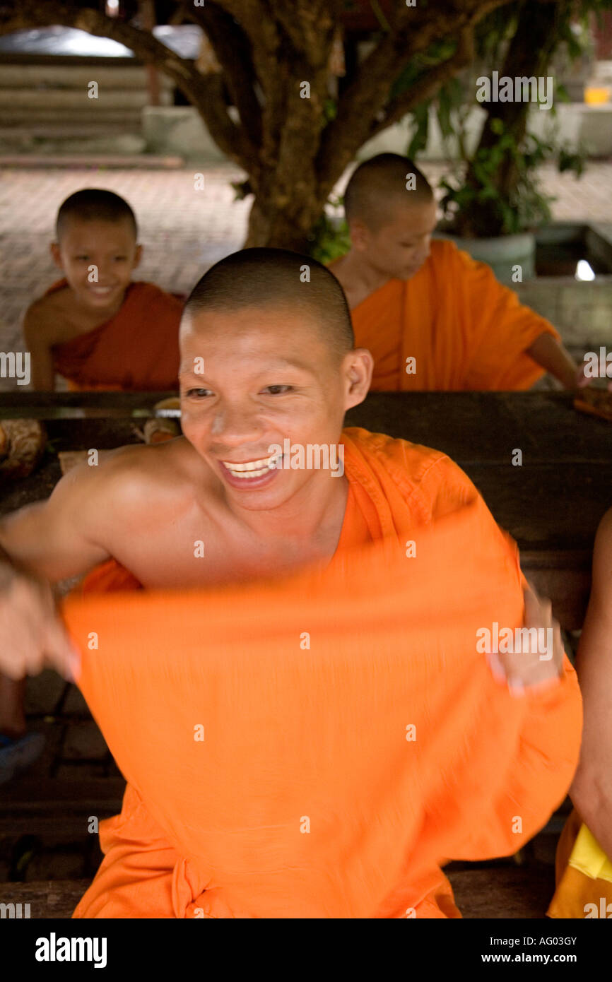 Buddhist monk adjusts his robe, in Luang Prabang, Laos. Stock Photo