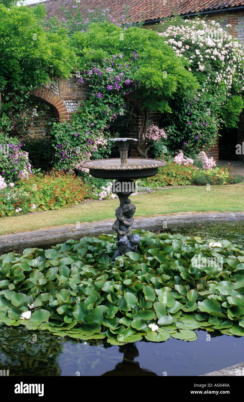 Lily pond, water feature in walled garden Stock Photo Alamy