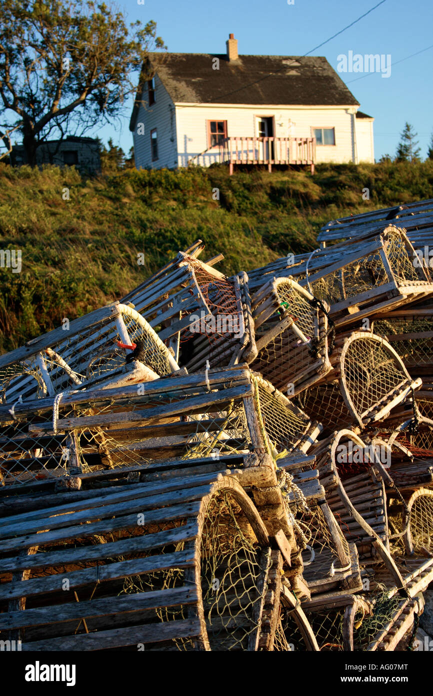 pile of old wooden lobster traps in front of vintage fishing house, Nova Scotia, Canada. Photo by Willy Matheisl Stock Photo