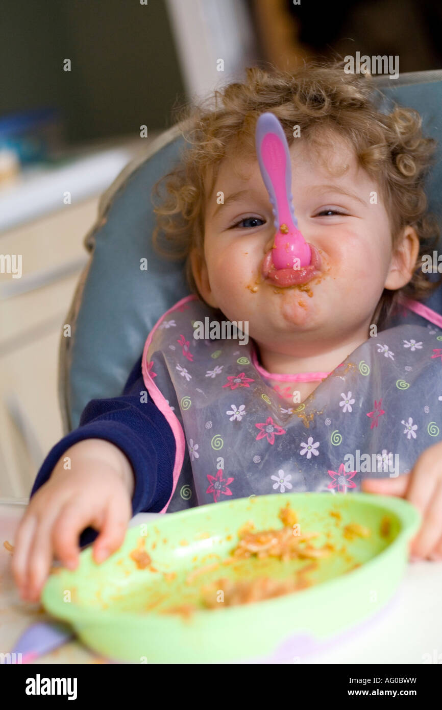 messy lunchtime at home for a two year old girl Stock Photo