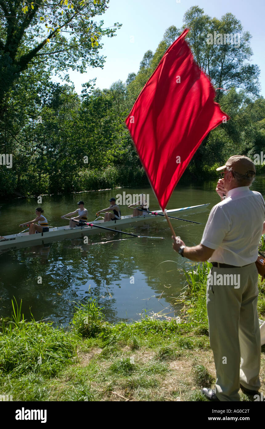 Umpire dropping red flag to start race during rowing regatta River Stour Sudbury Suffolk England 04 08 2007 Stock Photo