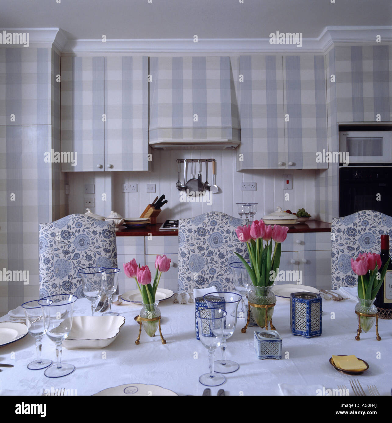 Pink Tulips On Dining Table In Kitchen With Blue Floral