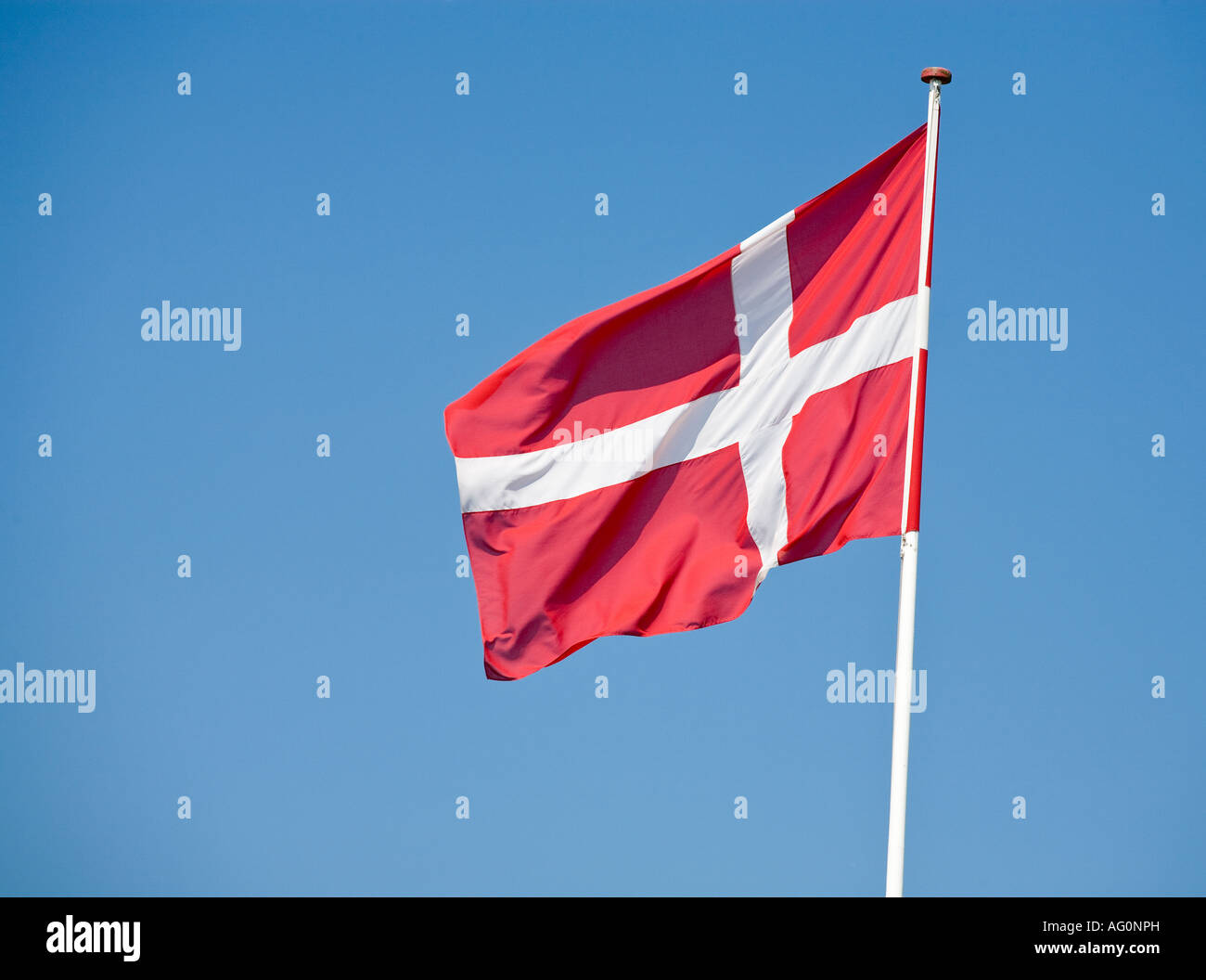 Danish Flag Blue Sky A Danish flag flying in a breeze in the sunshine and against a blue sky Funen Fyn Denmark Stock Photo