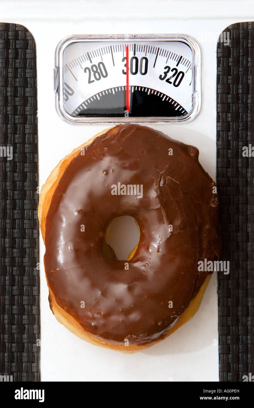 Donut tipping the scale Stock Photo
