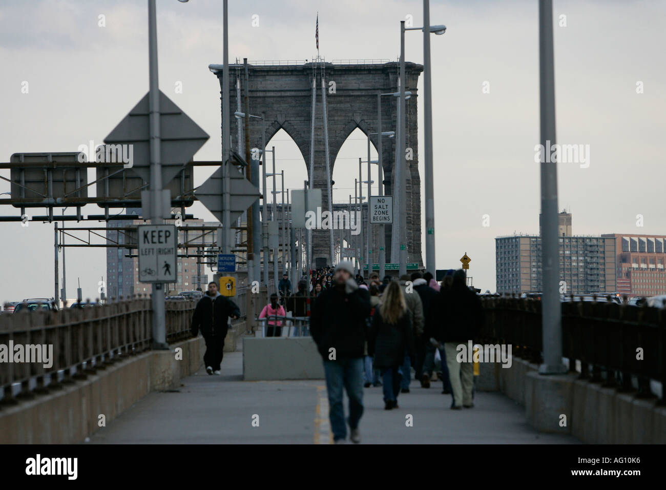 people walking across the brooklyn bridge new york city new york USA ...