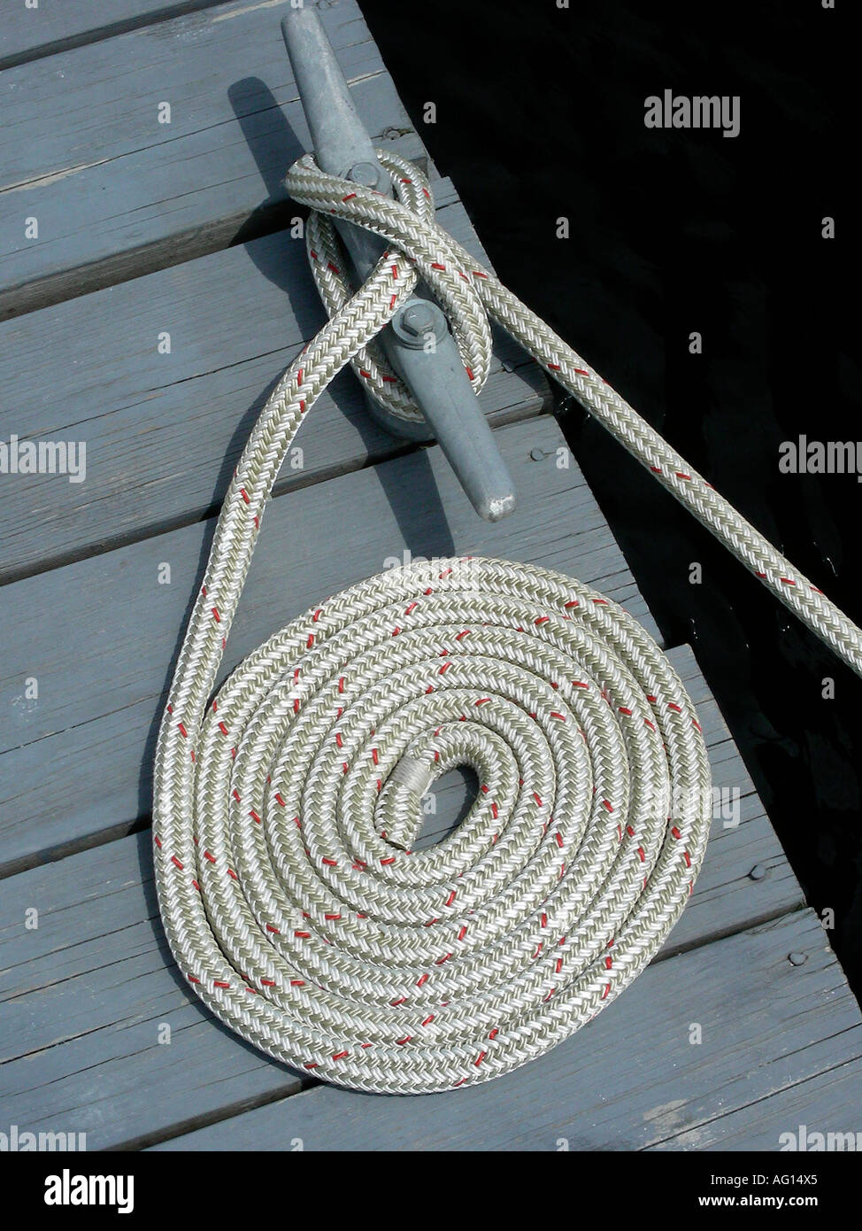 Coiled rope on mooring cleat Stock Photo Alamy
