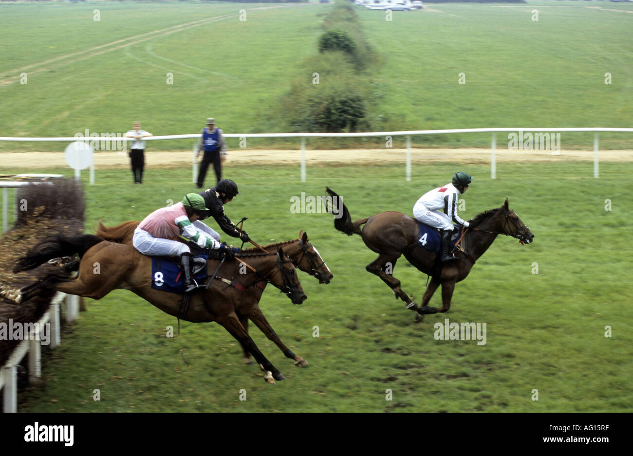 Horses jumping in steeplechase race at Stratford Races, Warwickshire
