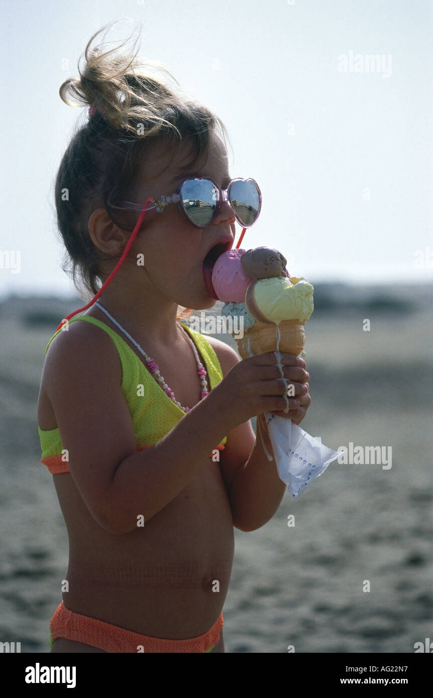 people, food and beverages, child at the beach with sunglasses and ice cream, girl, eating,holiday, Stock Photo