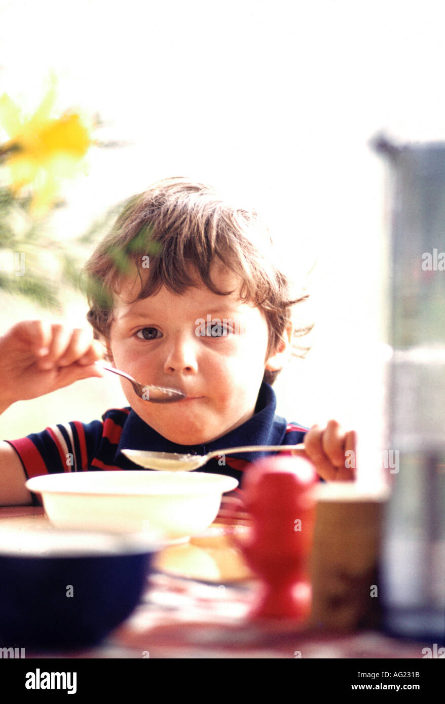 Young Child Eating Ice Cream With Two Spoons Stock Photo Alamy