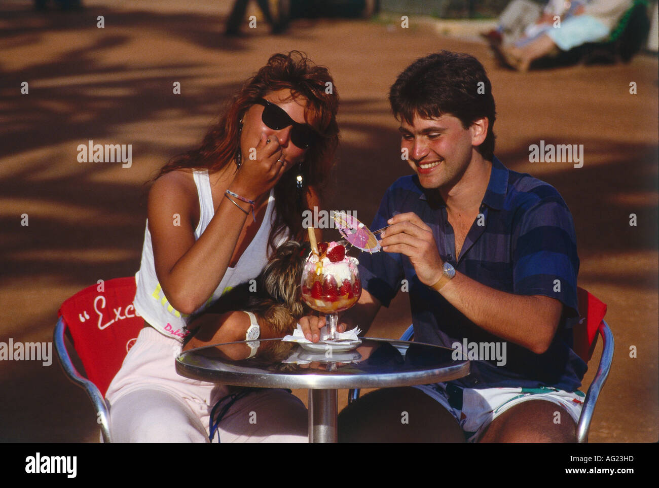 people, food and beverages, young couple eating ice cream, 1980s, sunglasses, sidewalk cafe, Stock Photo
