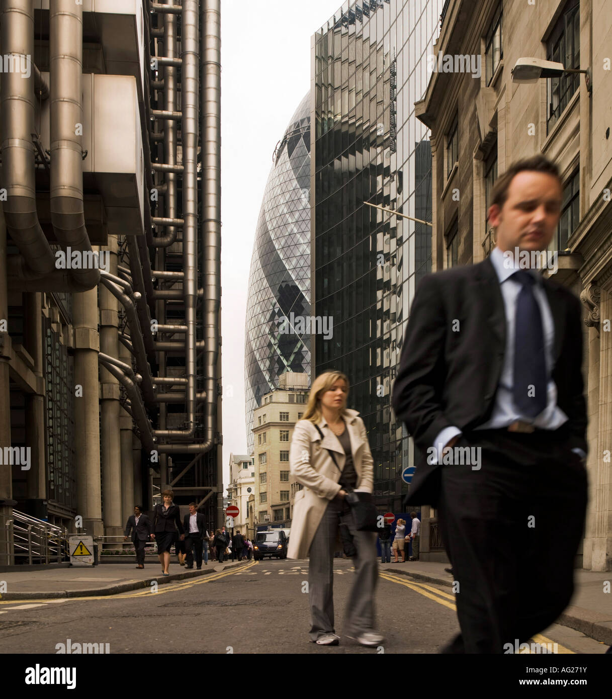 City worker businessman woman female male people crowd street walking past Lloyds London England UK Stock Photo