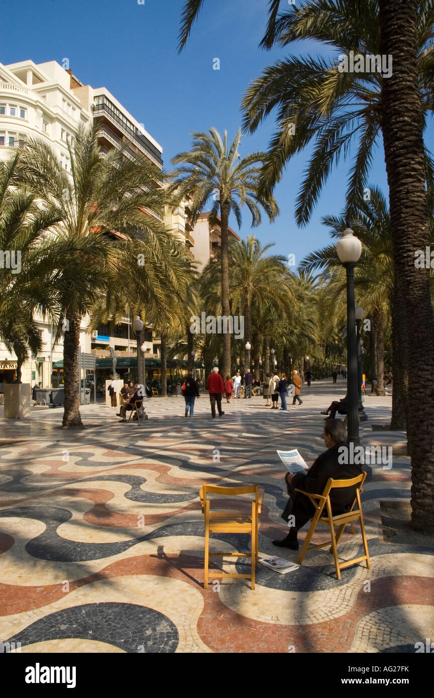 A man sitting on a chair reads the newspaper on the Esplanada de España in Alicante. Picture credit: Brian Hickey/Alamy Stock Photo