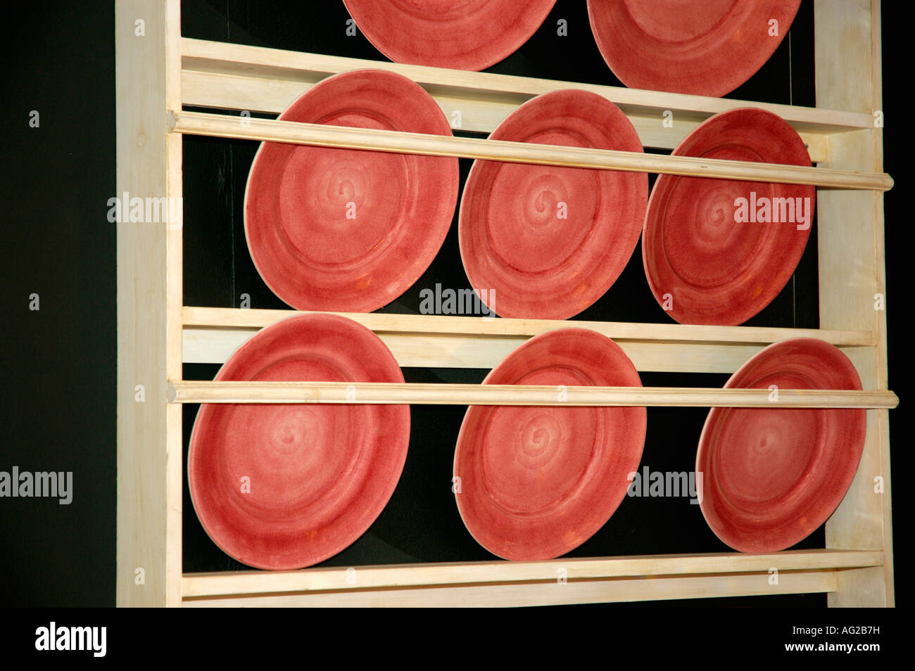 Pottery Plate Rack close up of red pottery plates on light wooden plate rack Stock Photo ...