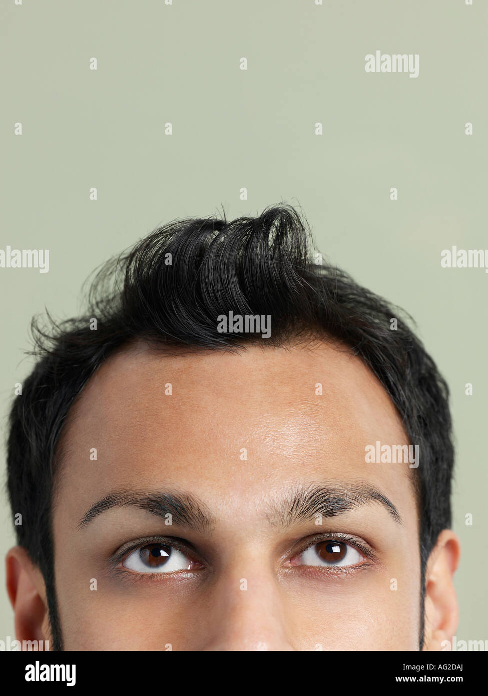 Mid adult man with messy hair, close-up of head, high section Stock Photo