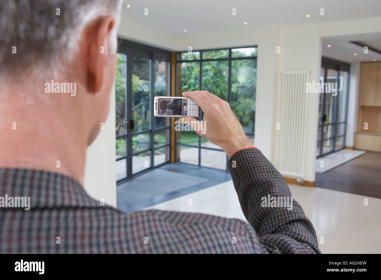 Real estate agent photographing new property