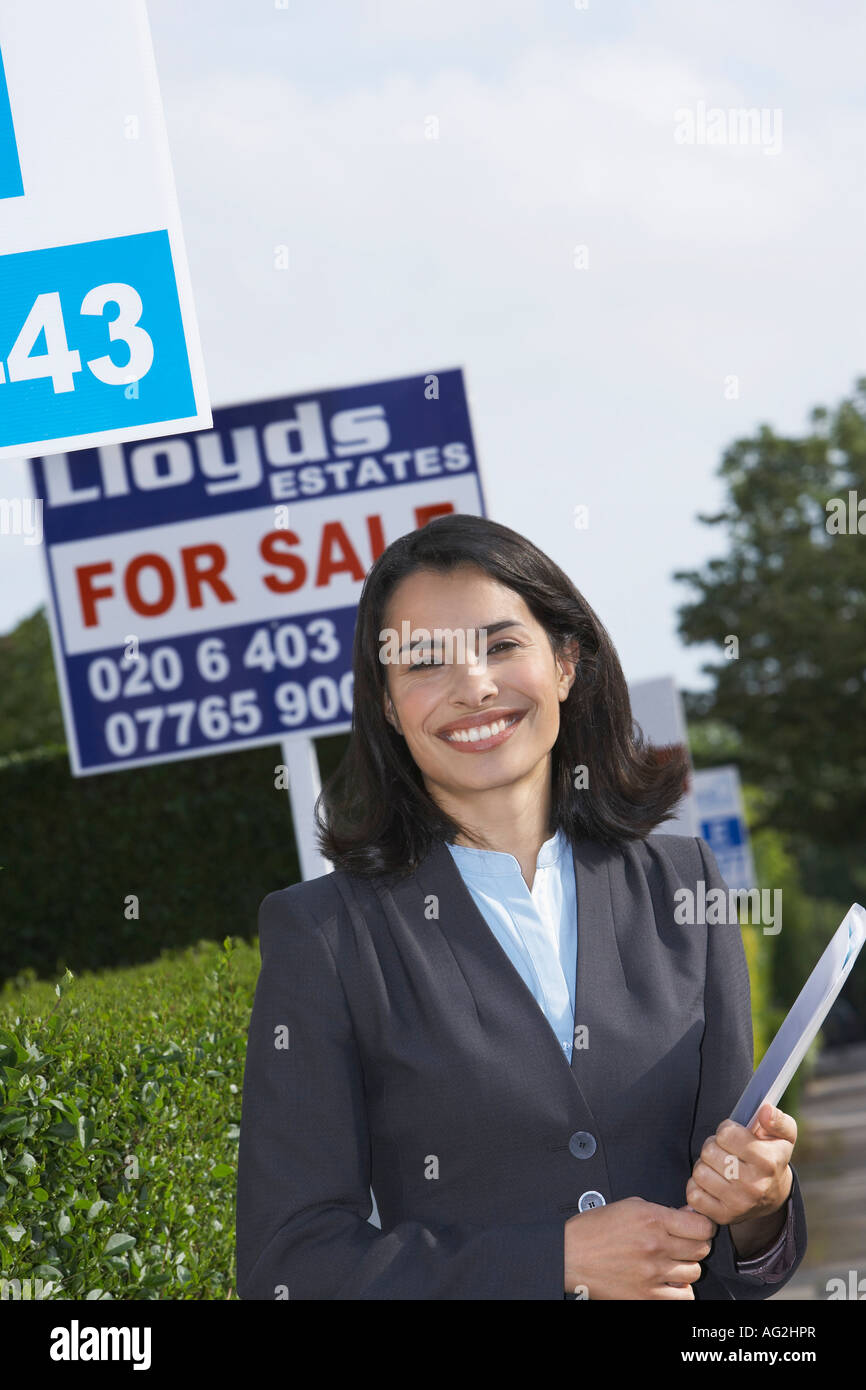 Real estate agent near for sale signs, portrait Stock Photo Alamy