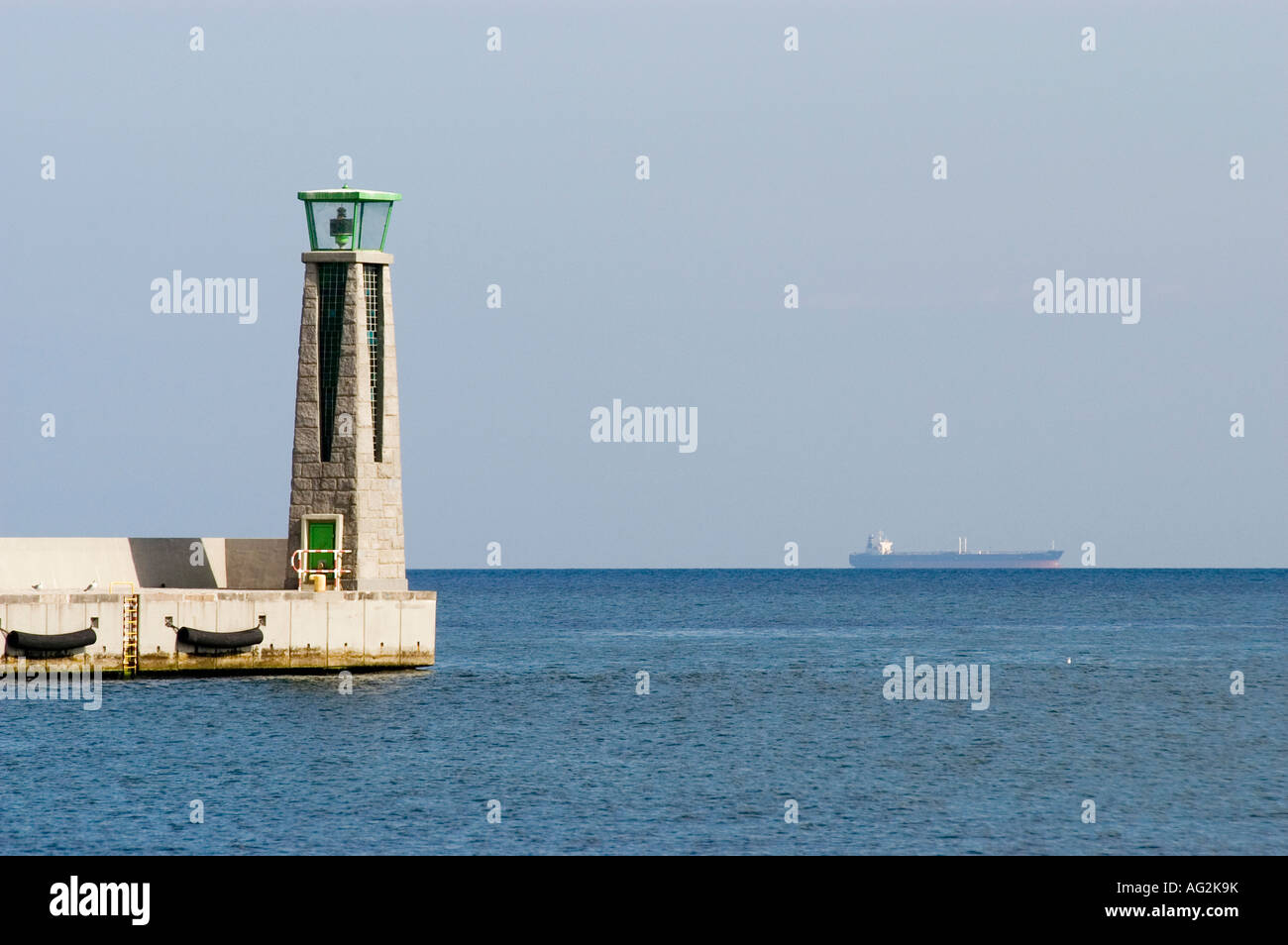 Sea lantern in Gdynia port with transport ship on ROADSTEAD, Poland Stock Photo