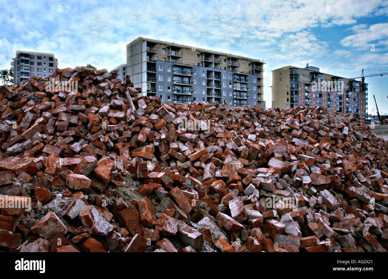 new blocks of flats condominium blocks behind heaps of bricks in