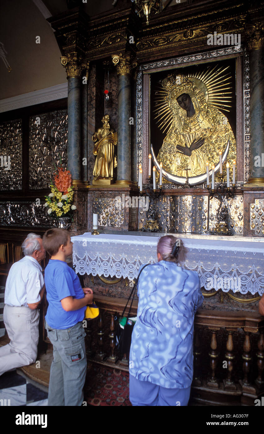 People worship the icon of the Virgin at the Gates of Dawn Vilnius old town Lithuania Stock Photo