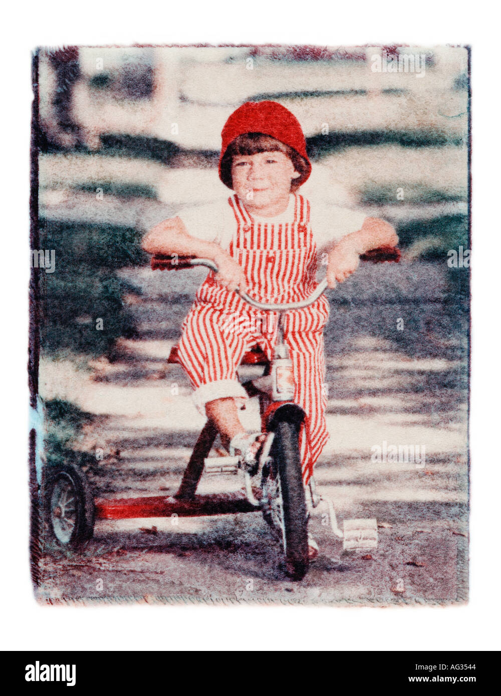 Polaroid transfer portrait of young girl on tricycle Stock Photo
