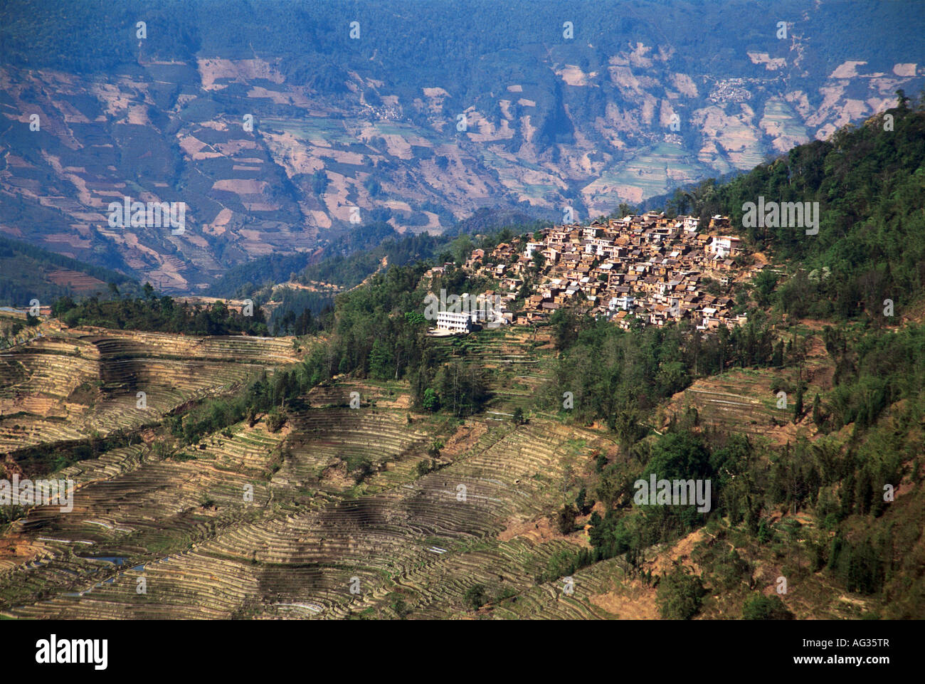 A mountain village rests atop terraced hills Stock Photo - Alamy