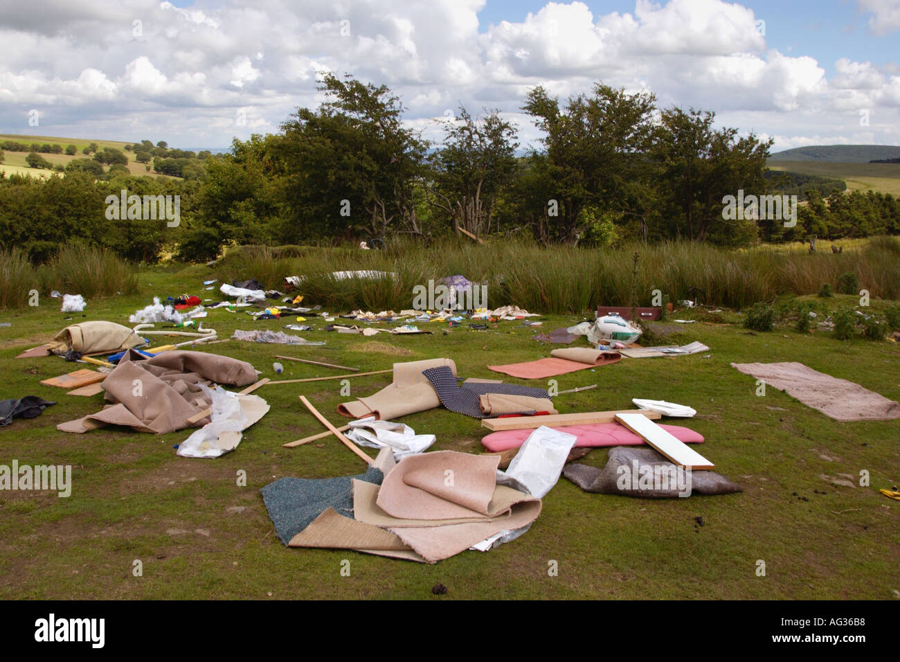 Illegal flytipping of household rubbish dumped in countryside on a hill ...
