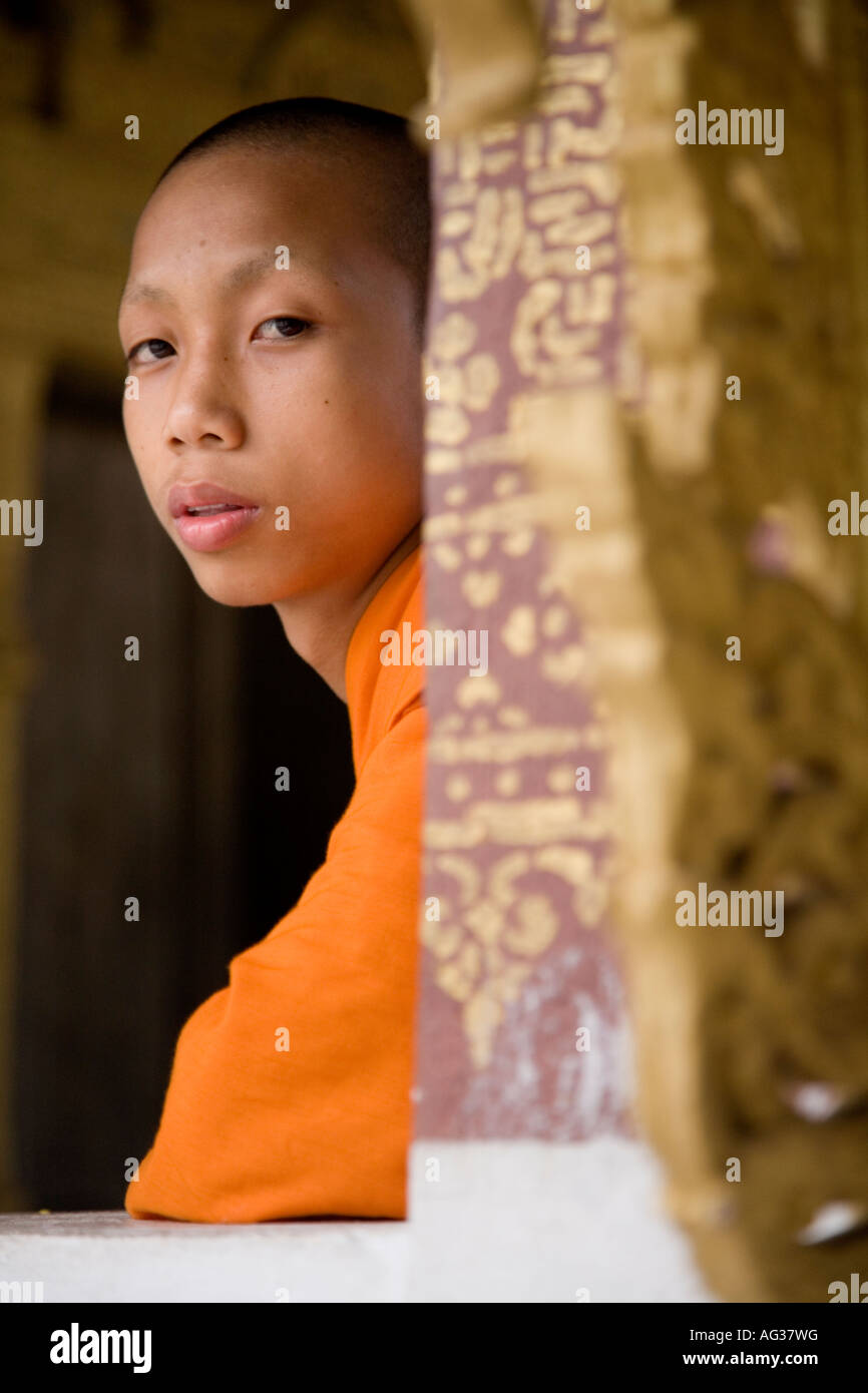 Buddhist monk glances sideways in Luang Prabang Laos Stock Photo