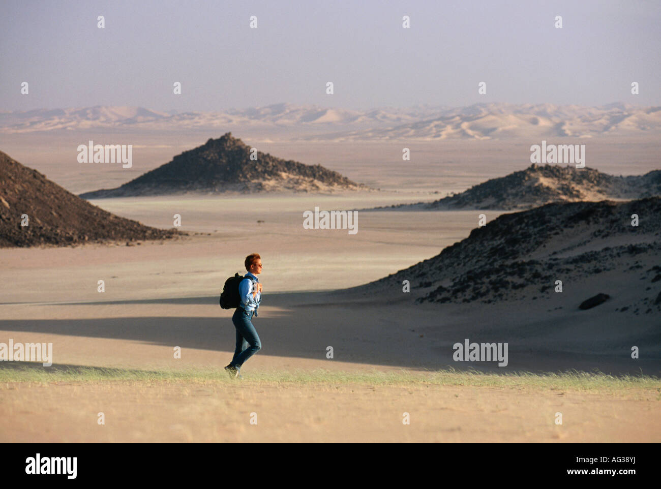 Algeria Djanet Tourist hiking in Sahara Stock Photo