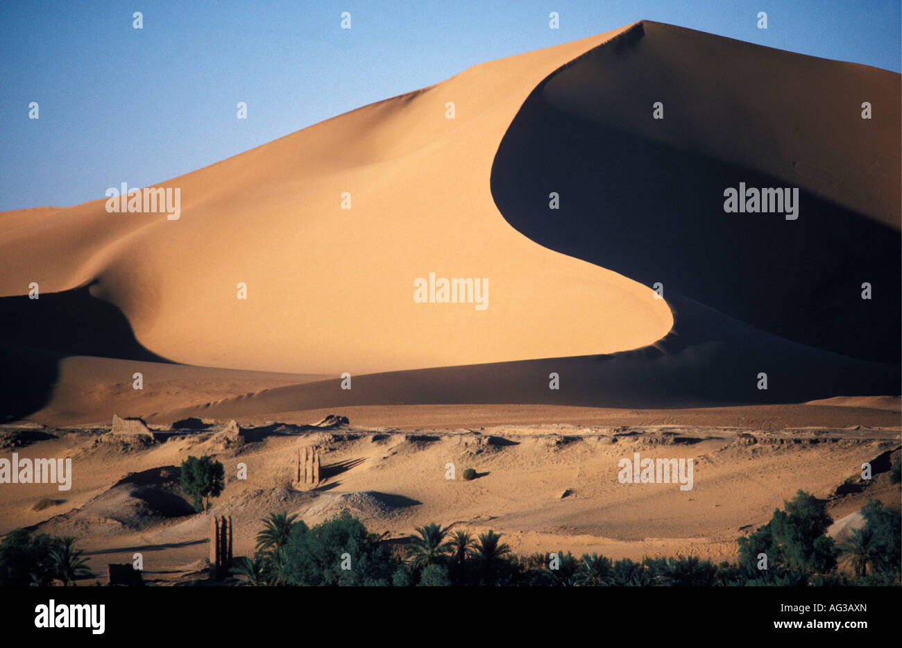 Algeria Taghit Sahara Traditional well with sand dunes in background Stock Photo