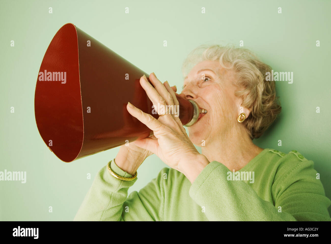 Woman talking into a bullhorn Stock Photo
