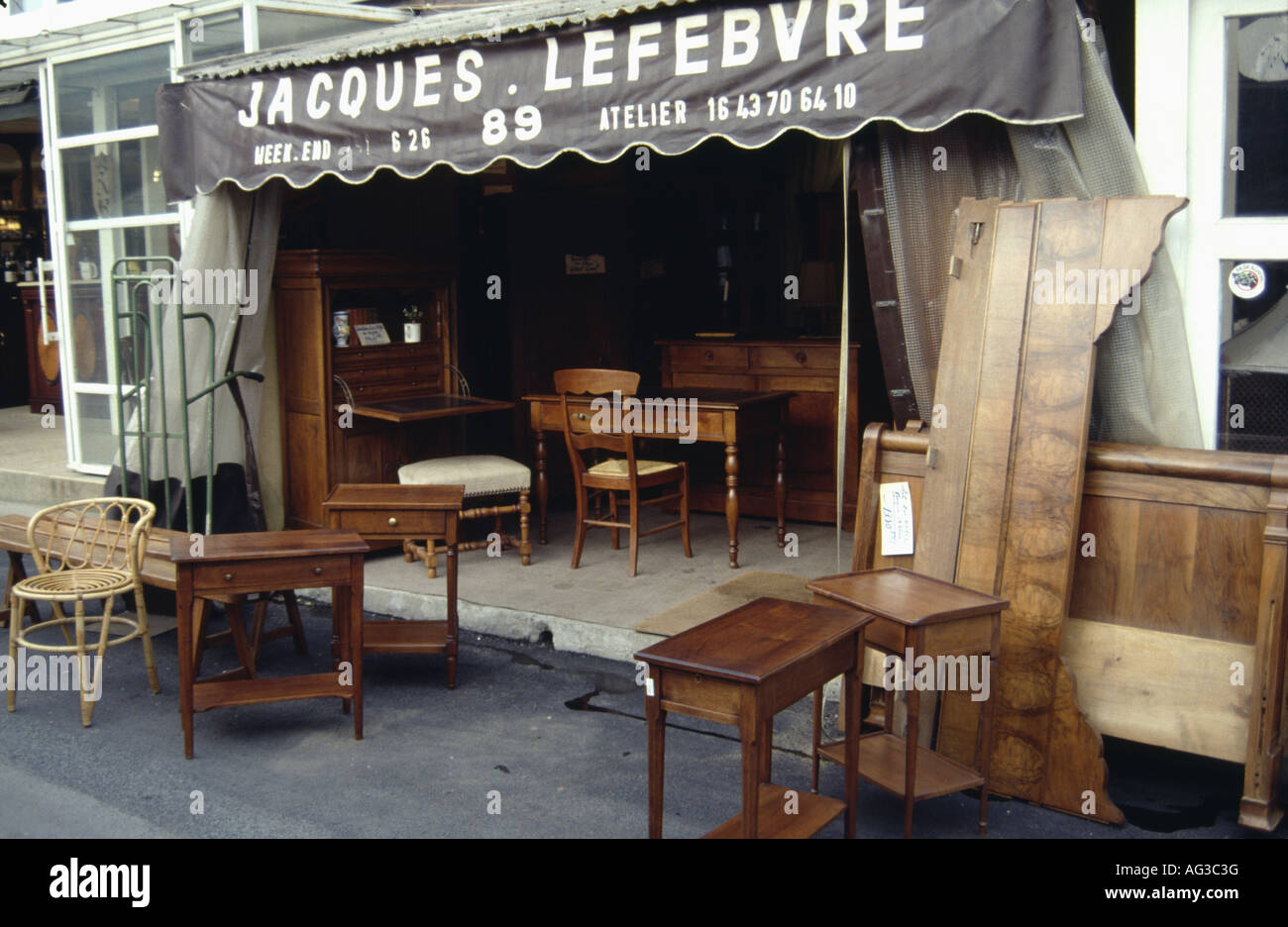 French antique shop with canopy over doorway and furniture on the