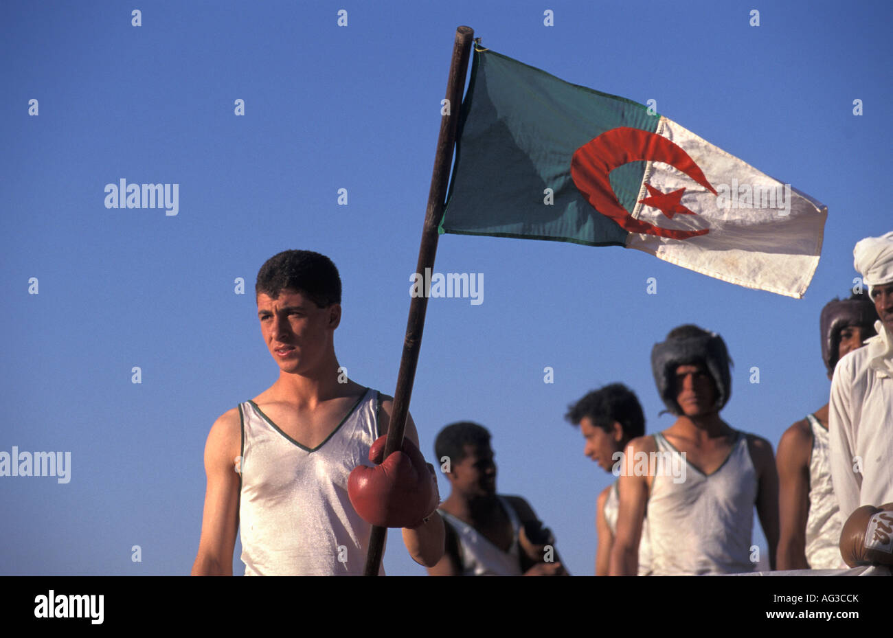 Algeria Tamanrasset Man holding Algerian flag Stock Photo