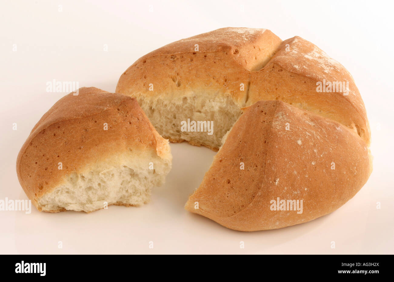 A loaf of bread divided into four quarters Stock Photo Alamy