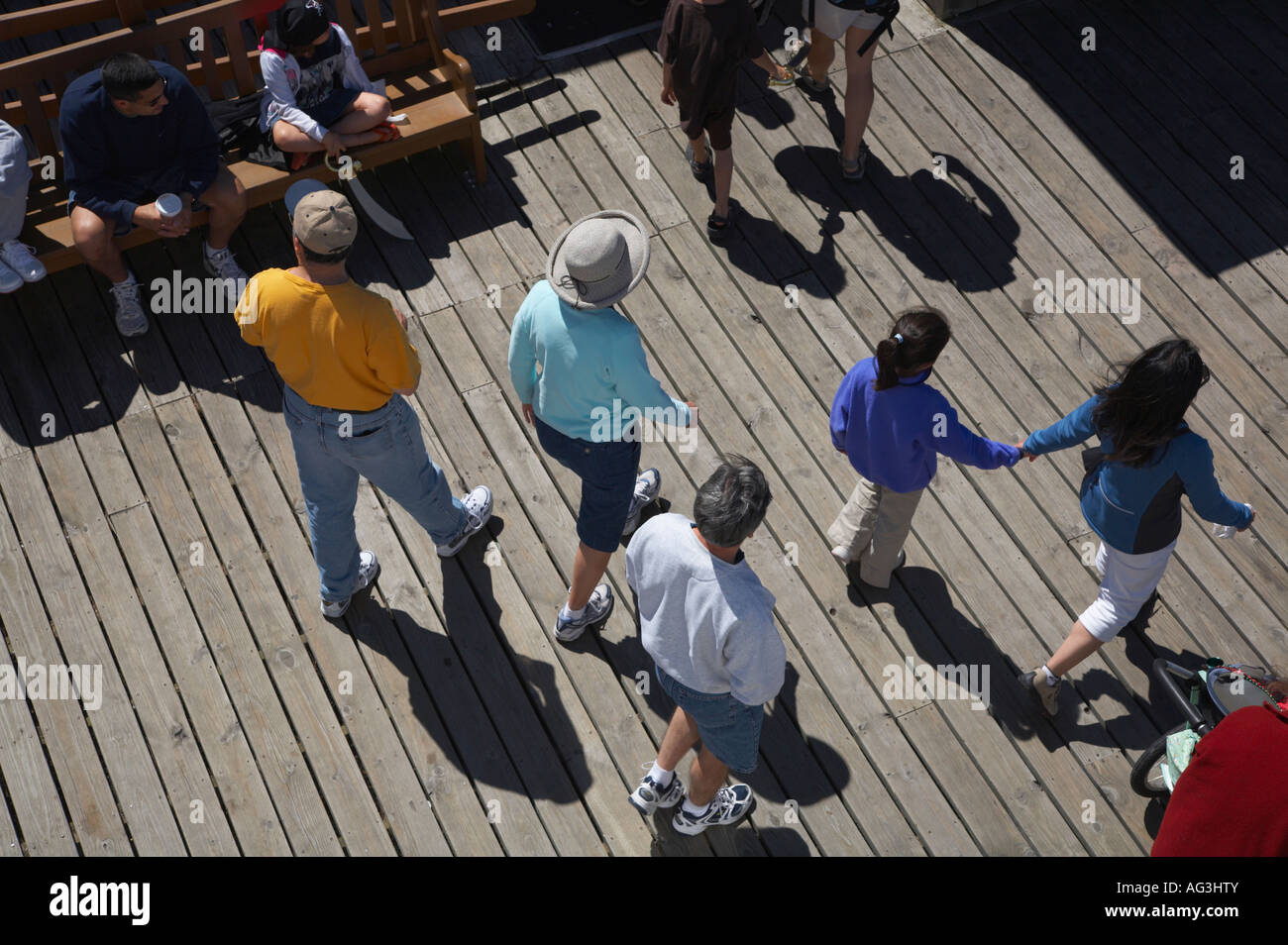 People walking on wooden dock taken from above Stock Photo