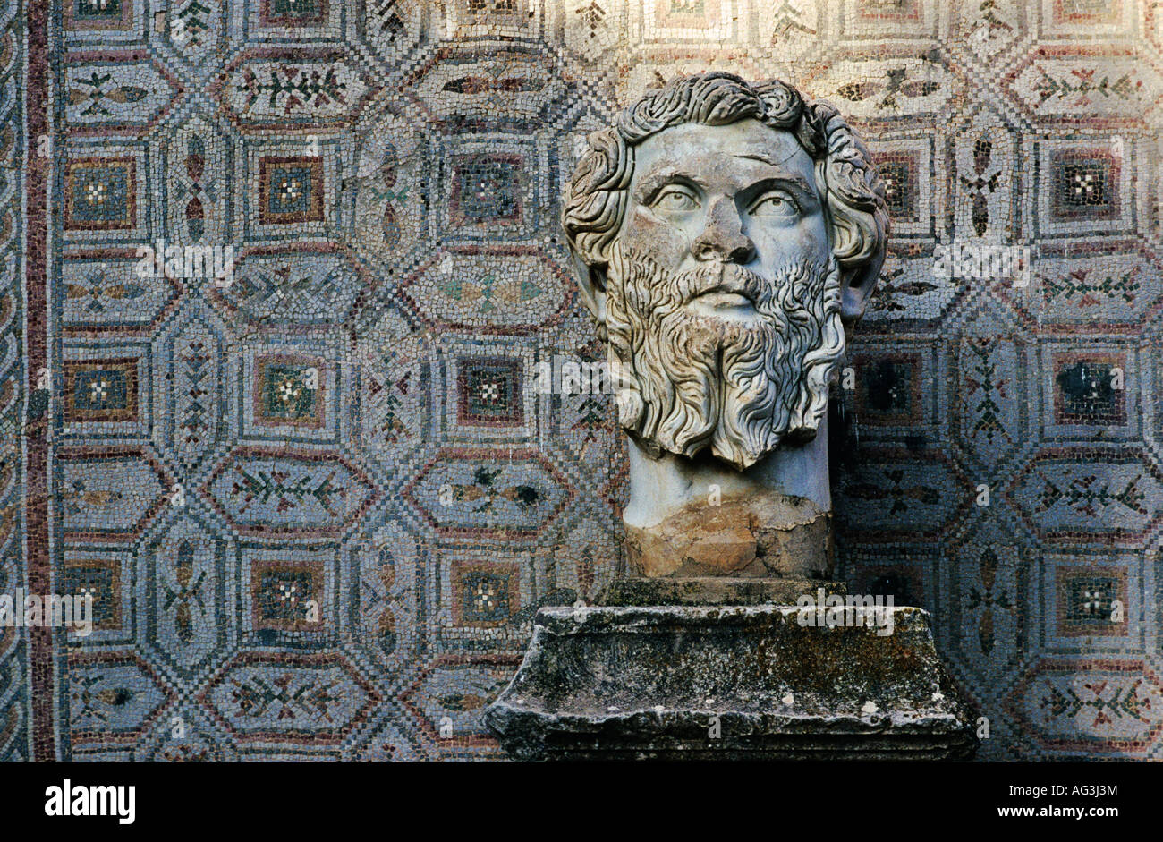 Algeria Djemila Roman statue by designed wall in Roman ruins Stock Photo