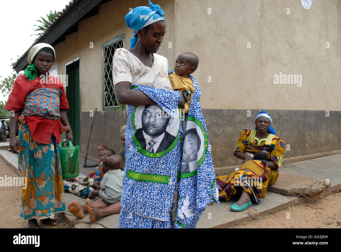 A woman carries a baby with a dress bearing the figure of the Congolese President Joseph Kabila Kabange, in North Kivu province, DR Congo Africa Stock Photo